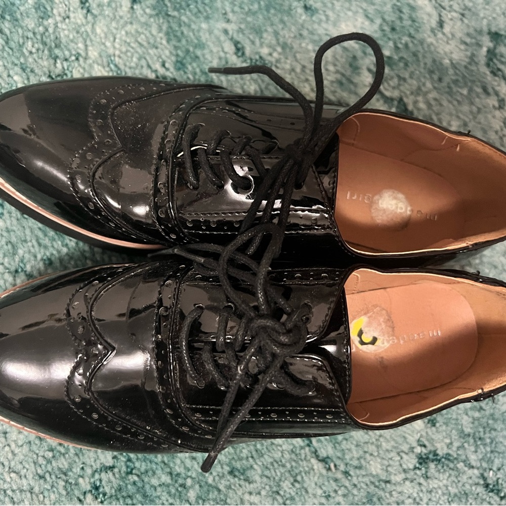 Madden Girl patent leather wing tip platforms
